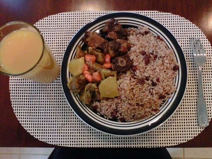 Curry goat, oxtails, rice w/ kidney beans  typical Jamaican sunday ...